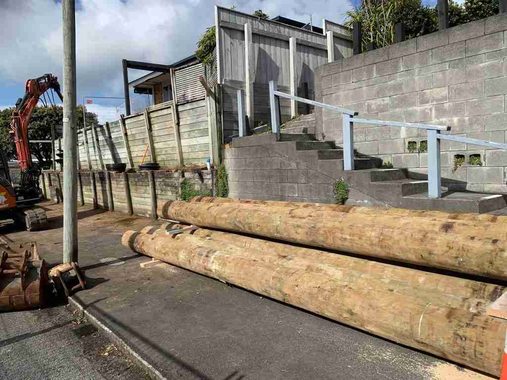 Original two-tier timber retaining wall leaning towards the footpath on Gaine Street, New Plymouth
