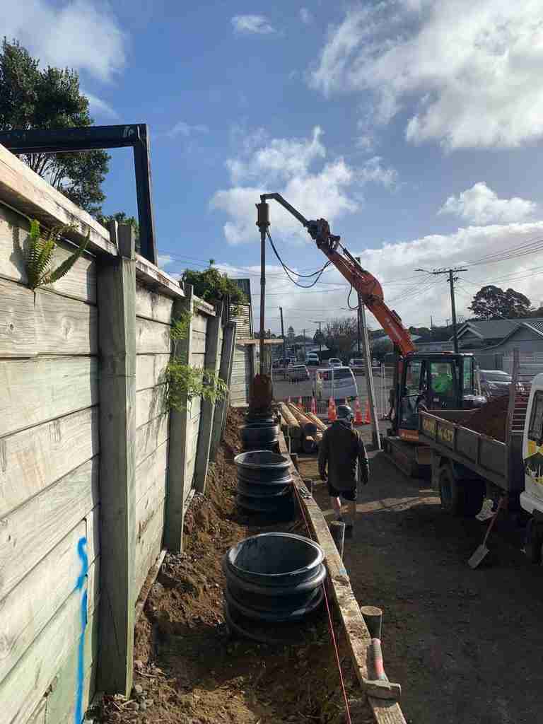 Pile holes being drilled for the new retaining wall in front of the existing wall in New Plymouth