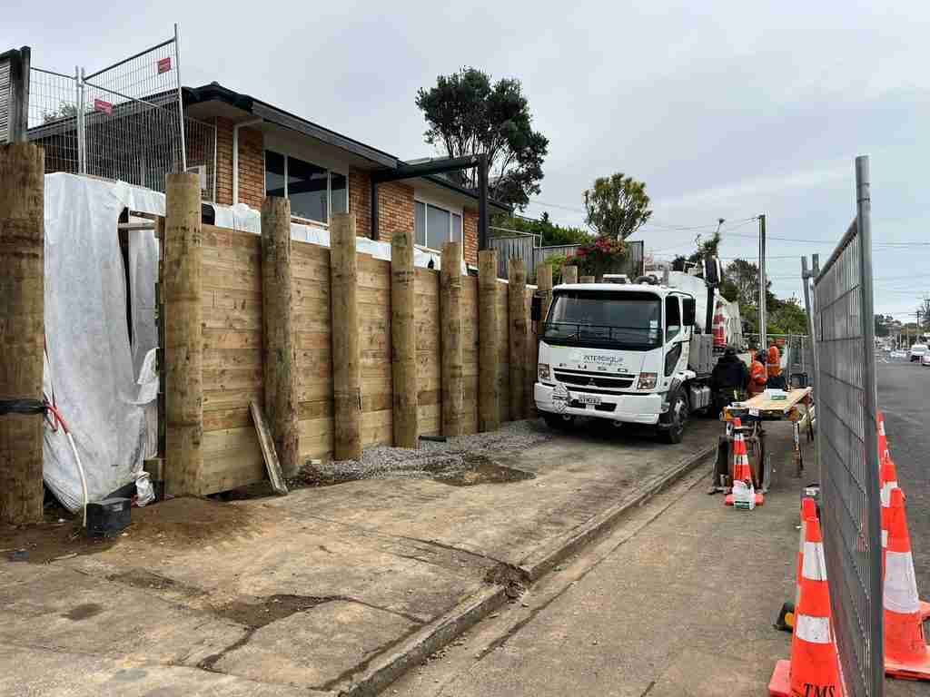 New engineered timber pole retaining wall under construction on Gaine Street, New Plymouth